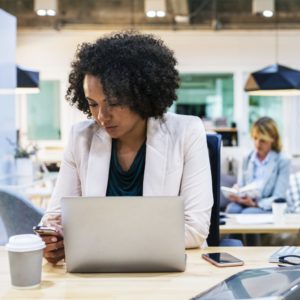 woman with laptop and phone